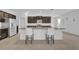 Well-equipped kitchen features granite countertops, stainless appliances, and bar stool seating at 14325 Hidden Ct, Clermont, FL 34711