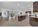 Modern kitchen and open living area with an island and stainless steel appliances at 14325 Hidden Ct, Clermont, FL 34711
