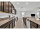 Open-concept kitchen with granite countertops and modern appliances at 14325 Hidden Ct, Clermont, FL 34711