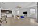 Open-concept living room and kitchen area with neutral tiling throughout at 14325 Hidden Ct, Clermont, FL 34711