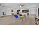 Open-concept living room and kitchen area with neutral tiling throughout and modern appliances at 14325 Hidden Ct, Clermont, FL 34711