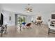 Bright living room with tile flooring, dining area, and access to the screened lanai at 14325 Hidden Ct, Clermont, FL 34711