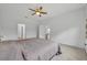 Spacious Primary bedroom with ceiling fan and adjoining bathroom doors for easy access at 14325 Hidden Ct, Clermont, FL 34711