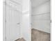 Walk-in closet features ample storage with wire shelving and carpet flooring at 14325 Hidden Ct, Clermont, FL 34711