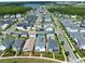 Scenic aerial view of a neighborhood featuring well-maintained homes and community amenities near a lake at 14525 Englert Aly, Orlando, FL 32827