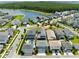 Picturesque aerial view of homes by a serene lake, offering a glimpse of community parks and recreational areas at 14525 Englert Aly, Orlando, FL 32827