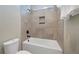 Tiled shower and tub featuring a niche for storage in bathroom at 14525 Englert Aly, Orlando, FL 32827