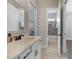 Bathroom with modern vanity, framed mirror, and tiled floor and shower at 14525 Englert Aly, Orlando, FL 32827