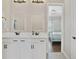 Bathroom featuring double sinks, framed mirrors, and modern fixtures at 14525 Englert Aly, Orlando, FL 32827