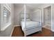 Bright bedroom features a four-poster bed and wood-look flooring at 14525 Englert Aly, Orlando, FL 32827