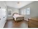 Bright bedroom showcases hardwood floors, windows with shutters and a dresser at 14525 Englert Aly, Orlando, FL 32827
