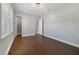 Bright bedroom with hardwood floors, white trim, and a ceiling light, offering a comfortable and inviting space at 14525 Englert Aly, Orlando, FL 32827