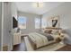 Calm and bright bedroom with neutral tones, hardwood floors, and large windows for ample natural light at 14525 Englert Aly, Orlando, FL 32827