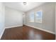 Inviting bedroom featuring hardwood floors, large windows with blinds, and a modern ceiling light at 14525 Englert Aly, Orlando, FL 32827