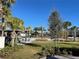 Community park featuring a green lawn, shady palm trees and a covered picnic area for residents at 14525 Englert Aly, Orlando, FL 32827