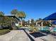 Inviting community pool area, showcasing modern lounge chairs and shade structures amid lush landscaping at 14525 Englert Aly, Orlando, FL 32827