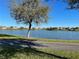 Scenic community view featuring a tranquil lake surrounded by homes and lush landscaping at 14525 Englert Aly, Orlando, FL 32827
