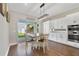 Bright dining area featuring a modern chandelier, white cabinets, and access to the backyard at 14525 Englert Aly, Orlando, FL 32827