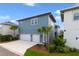 A modern two-story home with a two-car garage and meticulously landscaped front yard at 14525 Englert Aly, Orlando, FL 32827