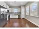 Well-lit kitchen with stainless steel appliances, white cabinetry, and hardwood flooring, creating a clean and modern space at 14525 Englert Aly, Orlando, FL 32827
