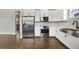 Modern kitchen with stainless steel appliances, white cabinets, and hardwood floors, seamlessly blending style and functionality at 14525 Englert Aly, Orlando, FL 32827