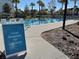 Community lap swim pool with lane signage, surrounded by lounge chairs and tropical landscaping at 14525 Englert Aly, Orlando, FL 32827