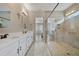 The main bathroom features a spacious double vanity and a walk-in shower with beautiful tile and a glass enclosure at 14525 Englert Aly, Orlando, FL 32827