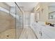 The main bathroom boasts dual vanities and a walk-in shower with pebble flooring and a glass enclosure at 14525 Englert Aly, Orlando, FL 32827