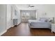 The main bedroom features wood-look floors, a ceiling fan, and several windows, offering plenty of natural light at 14525 Englert Aly, Orlando, FL 32827
