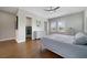Bright main bedroom features wood look floors, a ceiling fan, an ensuite bathroom, and a large walk-in closet at 14525 Englert Aly, Orlando, FL 32827