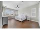 A lovely main bedroom with wood look floors, neutral walls, a ceiling fan, and lots of natural light at 14525 Englert Aly, Orlando, FL 32827