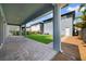 Inviting covered patio with brick pavers, perfect for outdoor relaxation and entertaining in a serene setting at 14525 Englert Aly, Orlando, FL 32827