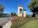 Beautiful community entrance sign framed by vibrant flowers and lush greenery, welcoming residents and visitors at 14525 Englert Aly, Orlando, FL 32827