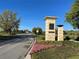 Attractive community entrance sign surrounded by colorful flowerbeds, marking the entrance to Lake Nona at 14525 Englert Aly, Orlando, FL 32827