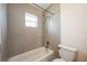 Bright bathroom showcasing a tiled shower over tub and toilet at 1470 Winston Rd, Maitland, FL 32751