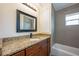 Updated bathroom features granite counters, a modern vanity, and tiled shower/tub at 1470 Winston Rd, Maitland, FL 32751