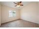 Cozy carpeted bedroom with ceiling fan and bright window at 1470 Winston Rd, Maitland, FL 32751