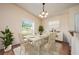 Elegant dining room with a classic chandelier, seating for six, and ample natural light at 1470 Winston Rd, Maitland, FL 32751