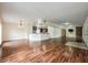 Open concept living room with wood floors that connects to the kitchen and dining area at 1470 Winston Rd, Maitland, FL 32751