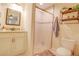 Bright bathroom features a shower, vanity with granite countertop, and modern fixtures at 15303 Sw 52Nd Cir, Ocala, FL 34473
