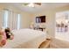 Bright bedroom boasts a comfortable bed, large window, and view into an eat-in kitchen at 15303 Sw 52Nd Cir, Ocala, FL 34473