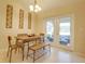 Cozy dining area with wood table set and access to the outdoor patio through glass doors at 15303 Sw 52Nd Cir, Ocala, FL 34473