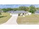 Charming single-story home featuring a well-manicured lawn and attached two car garage at 15303 Sw 52Nd Cir, Ocala, FL 34473