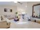 Bright and spacious living room showcasing tile floors and a large sectional couch at 15303 Sw 52Nd Cir, Ocala, FL 34473