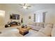 Comfortable living room featuring tile floors, a large couch, and a ceiling fan at 15303 Sw 52Nd Cir, Ocala, FL 34473