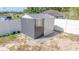 Gray and white shed with window and metal roof sits in yard at 15303 Sw 52Nd Cir, Ocala, FL 34473