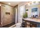 Modern bathroom features a tiled walk-in shower and updated vanity with stylish fixtures at 156 Carrera Ave, Davenport, FL 33897