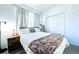 Cozy bedroom with a comfortable bed, neutral decor, and plenty of natural light from the window at 156 Carrera Ave, Davenport, FL 33897