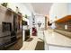 Modern kitchen featuring stainless steel appliances, granite countertops, white cabinets, and tile backsplash at 156 Carrera Ave, Davenport, FL 33897