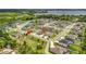 Aerial view of a residential community near a lake features a nice layout with many homes and trees at 15865 Bradicks Ct, Clermont, FL 34711